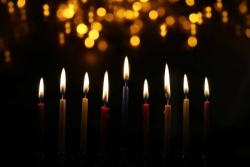 Fully lit menorah in the dark